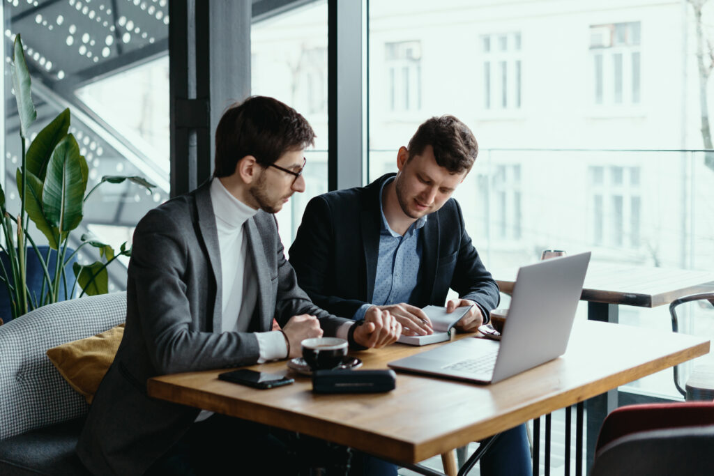 Two young businessman having a successful meeting at restaurant.