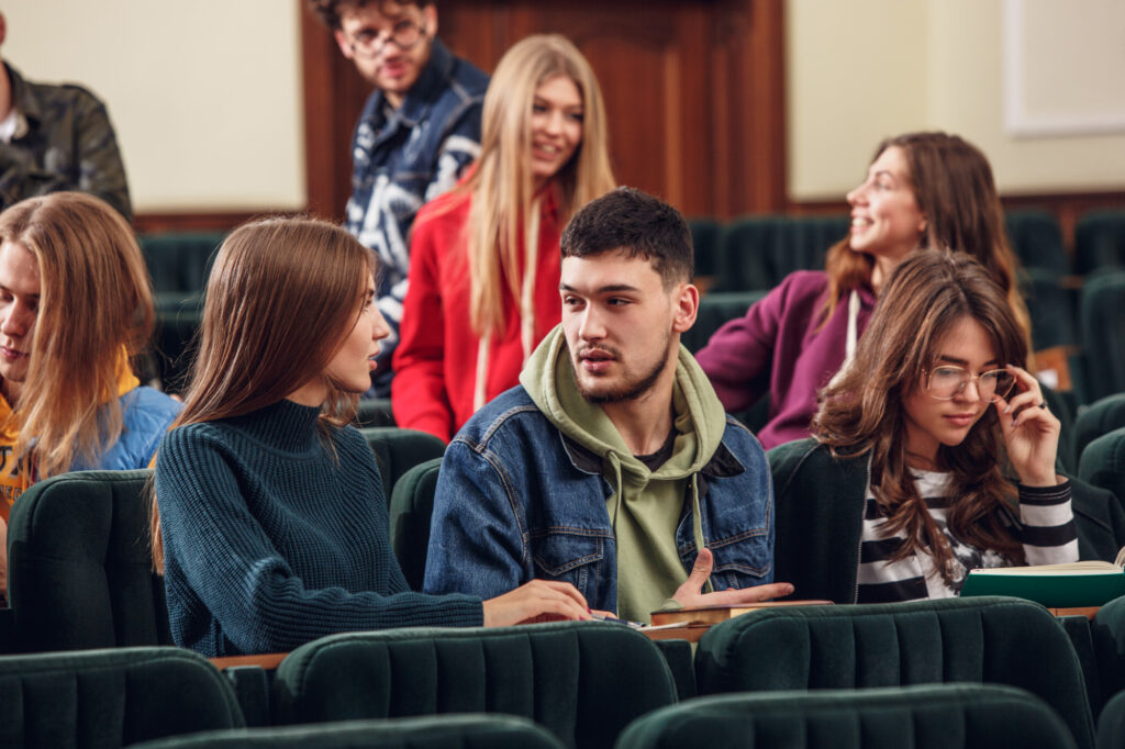 group-cheerful-happy-students-sitting-reading-hall-before-lesson