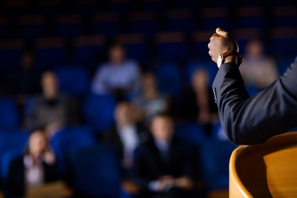 Male business executive giving a speech at conference centre